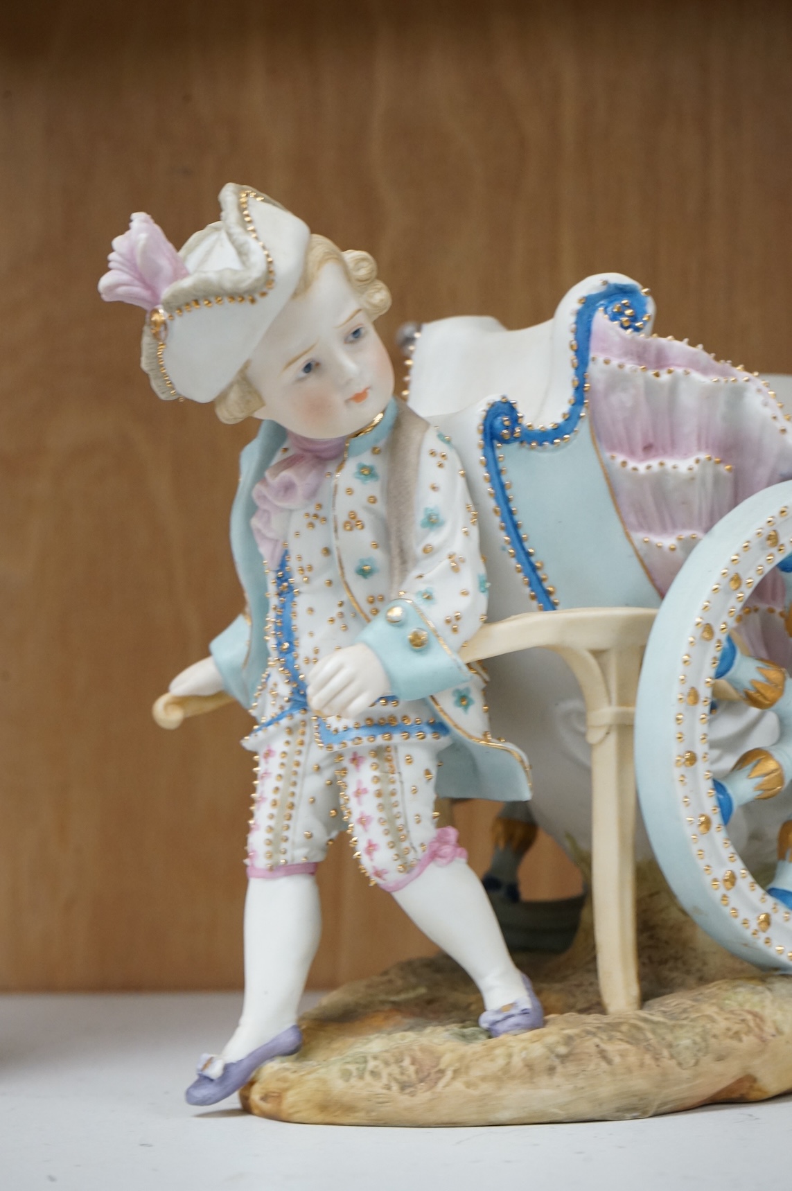 A pair of French coloured biscuit porcelain carriage group centre pieces, 21cm wide